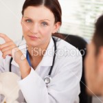 stock-photo-18190564-female-doctor-showing-patient-a-spine