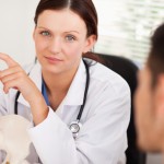 A female doctor showing patient a spine
